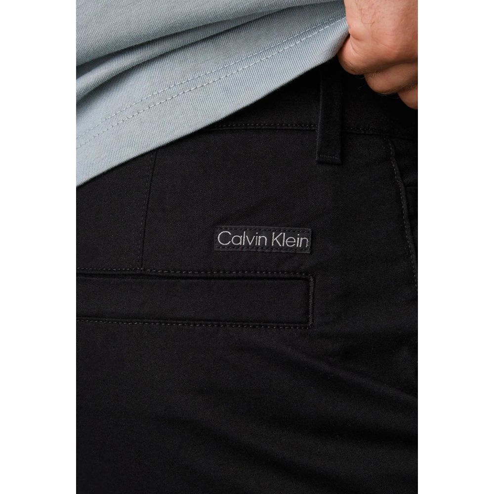 Close-up of Calvin Klein Jeans Black Recycled Cotton Chino Pants showing logo detail, emphasizing sustainable fashion.