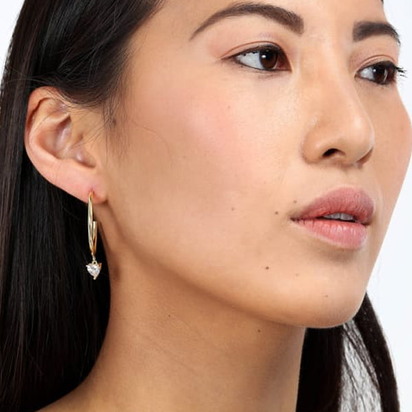 Woman wearing LA PETITE STORY JEWELRY Mod. LPS02AQM31 gold hoop earring with dangling charm