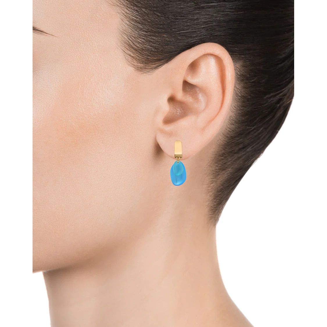 Close up of a woman wearing a VICEROY JEWELS Mod. 13142E100-59 silver earring with a blue drop gemstone on ear.