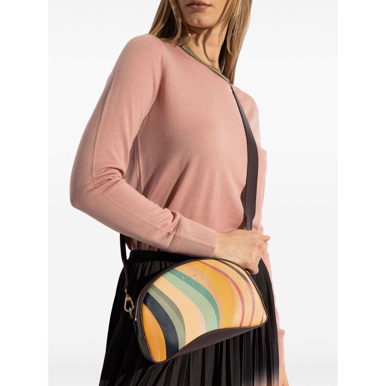 Woman wearing a Paul Smith Swirl leather crossbody bag with cedar brown detachable strap, size 22x15x8 cm