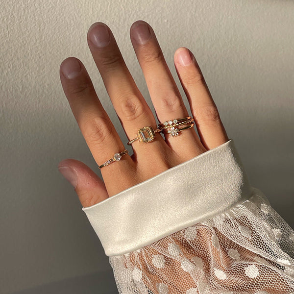 Hand adorned with 24KAE JEWELS JEWELRY Mod. 12401Y/56 showcasing elegant rings in a delicate lace-sleeved setting.