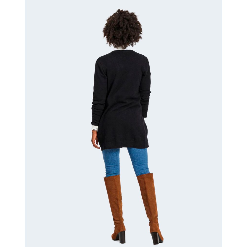 Back view of model wearing Vila Clothes Black Viscose Cardigan paired with jeans and brown boots.