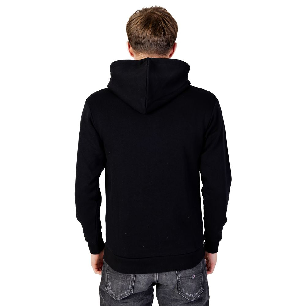 Back view of Jack Jones Black Polyester Hoodie worn by a man, showcasing its design and comfort.