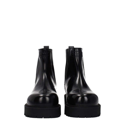 Givenchy Black Leather Ankle Boots with front and back logo, featuring a rubber sole and round toe design.