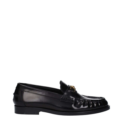 Versace Black Leather Slip-On Loafers with front logo and round toe, designed for casual wear, featuring low flat heel and leather sole.