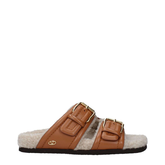 Valentino Garavani Brown Leather Slippers with buckle closure and open toe design on rubber sole, side view.