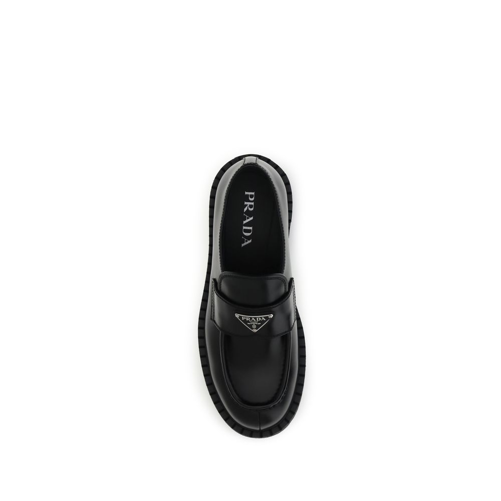 Prada Black Calf Leather Bos Taurus Slip-On Loafers with enameled metal triangle on top view.