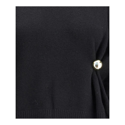 Close-up of Loulou De Saison Black Wool Sweatshirt featuring gold detail, elegant draped design, and sophisticated craftsmanship, perfect for AW25.