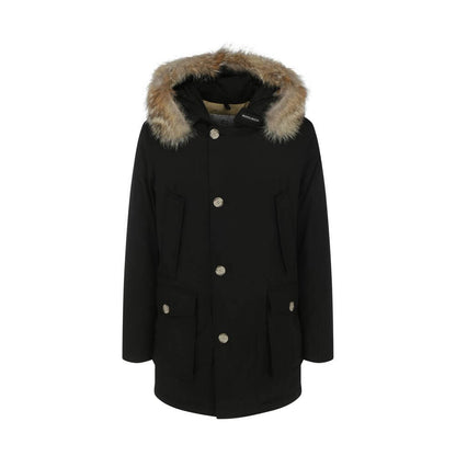 Woolrich Black Cotton Parka with fur hood, front zip and button closure, and patch pockets for AW25. Made in Bulgaria, 60% cotton, 40% polyamide.