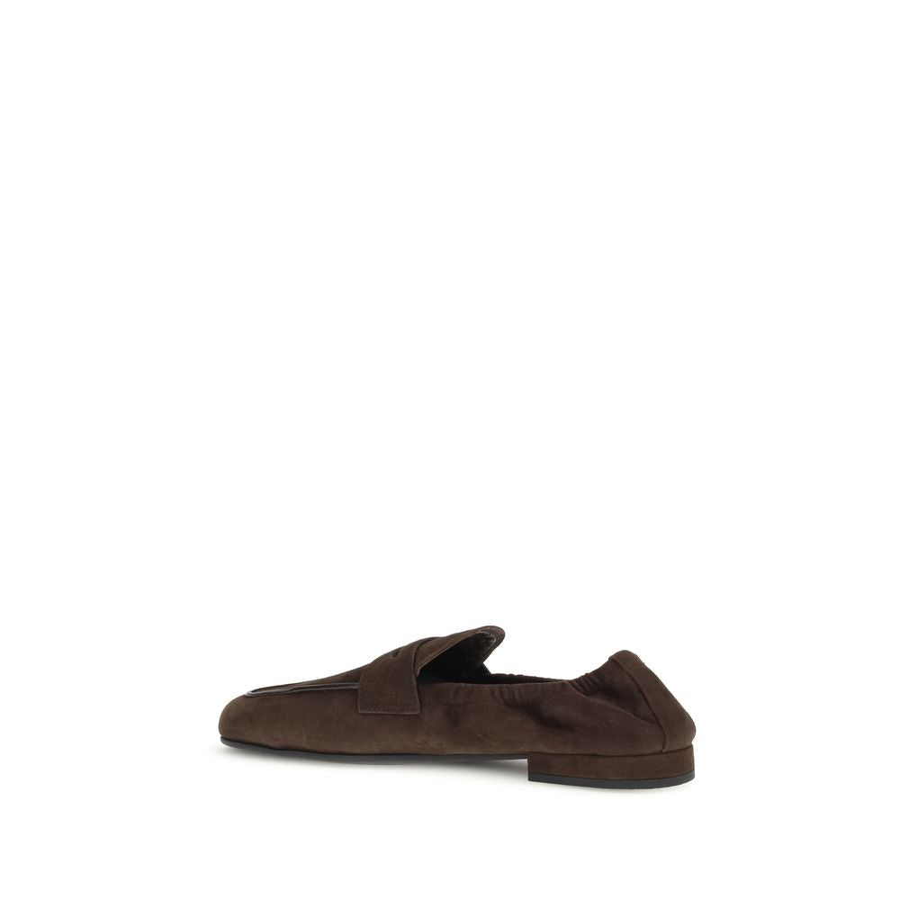 Prada Brown Lamb Ovis Aries Aries Slip-On Loafers with suede and leather horsebit detail, rubber sole, and screen-printed logo.