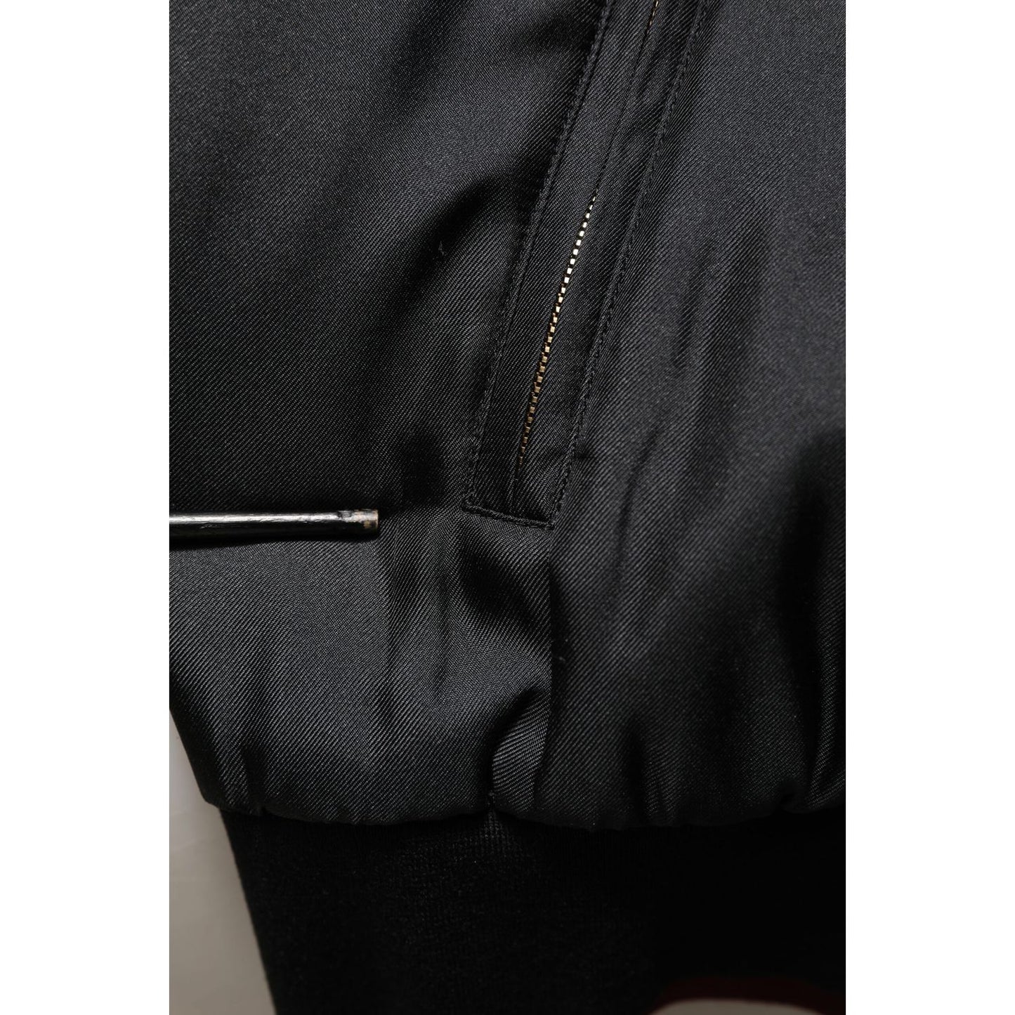 Close-up of Dolce & Gabbana Black Red Floral Silk Bomber Blouson Jacket showing detail of black fabric and zipper.