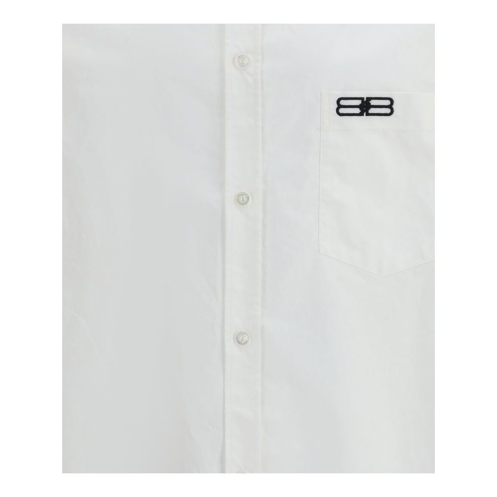 Balenciaga White Cotton Dress Shirt with classic collar, front button closure, asymmetrical hem, and embroidered logo on pocket.