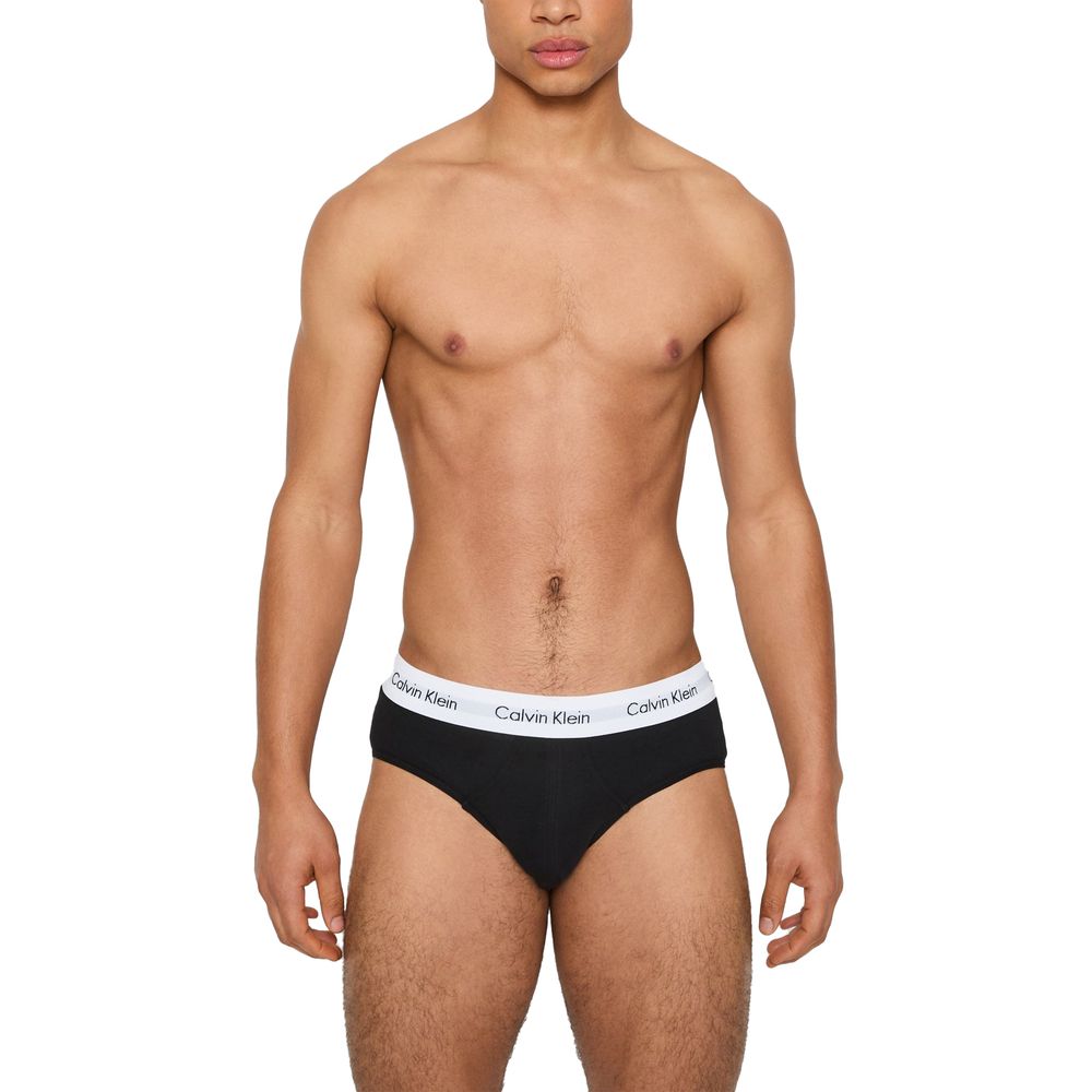 Model wearing Calvin Klein Underwear Black And White Cotton Briefs with logo waistband.