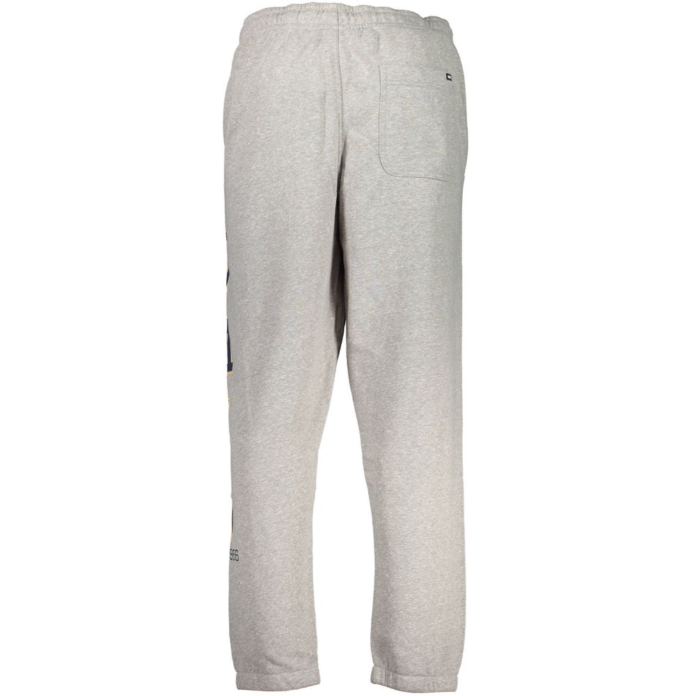 Vans Gray Cotton Pant with elastic waist, fleece material, and logo on pocket. Features elastic ankles and three pockets for sports.