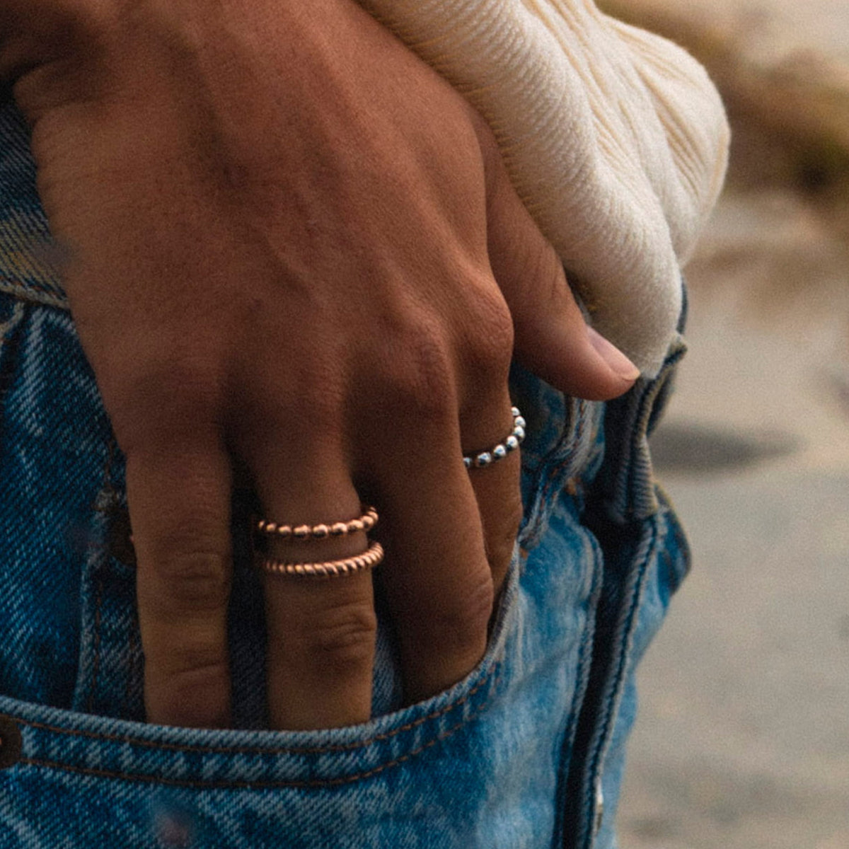 Close-up of a hand with rings in pocket wearing AN JEWELS JEWELRY Mod. AR.R2NS04R-8, casual style with denim jeans.