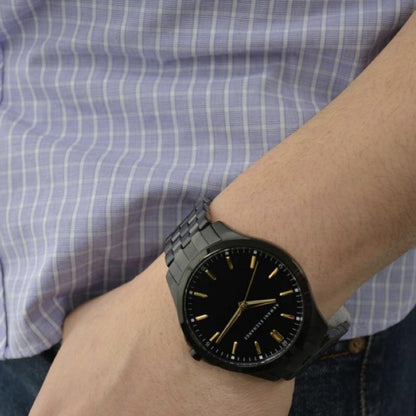 Man wearing A|X ARMANI EXCHANGE Mod. HAMPTON stainless steel wristwatch, featuring quartz movement and water resistance up to 5 ATM.