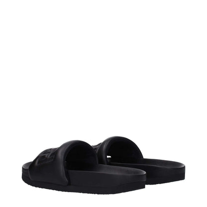 Ambush Black Leather Slippers with open toe and front logo design, featuring a rubber sole, viewed from the back angle.