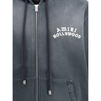 Amiri Black Cotton Sweatshirt featuring "Hollywood" motif, kangaroo pocket, and zip closure, AW25 streetwear style, regular fit.