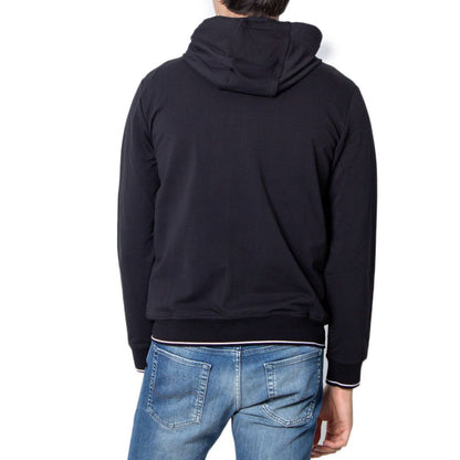 Rear view of man wearing Armani Exchange Black Cotton Hoodie with hood up paired with blue jeans, showcasing modern and casual style.