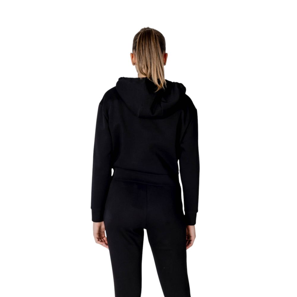 Back view of woman wearing Armani Exchange Black Cotton Hoodie with drawstring hood, showcasing a sleek, contemporary style.