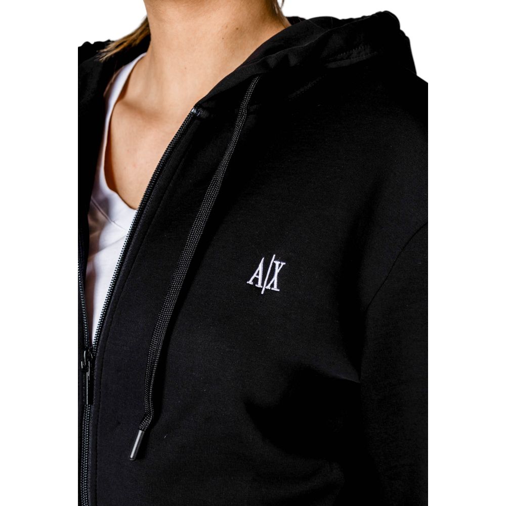 Woman wearing Armani Exchange Black Cotton Hoodie with AX logo on chest, featuring zip closure and adjustable hood.
