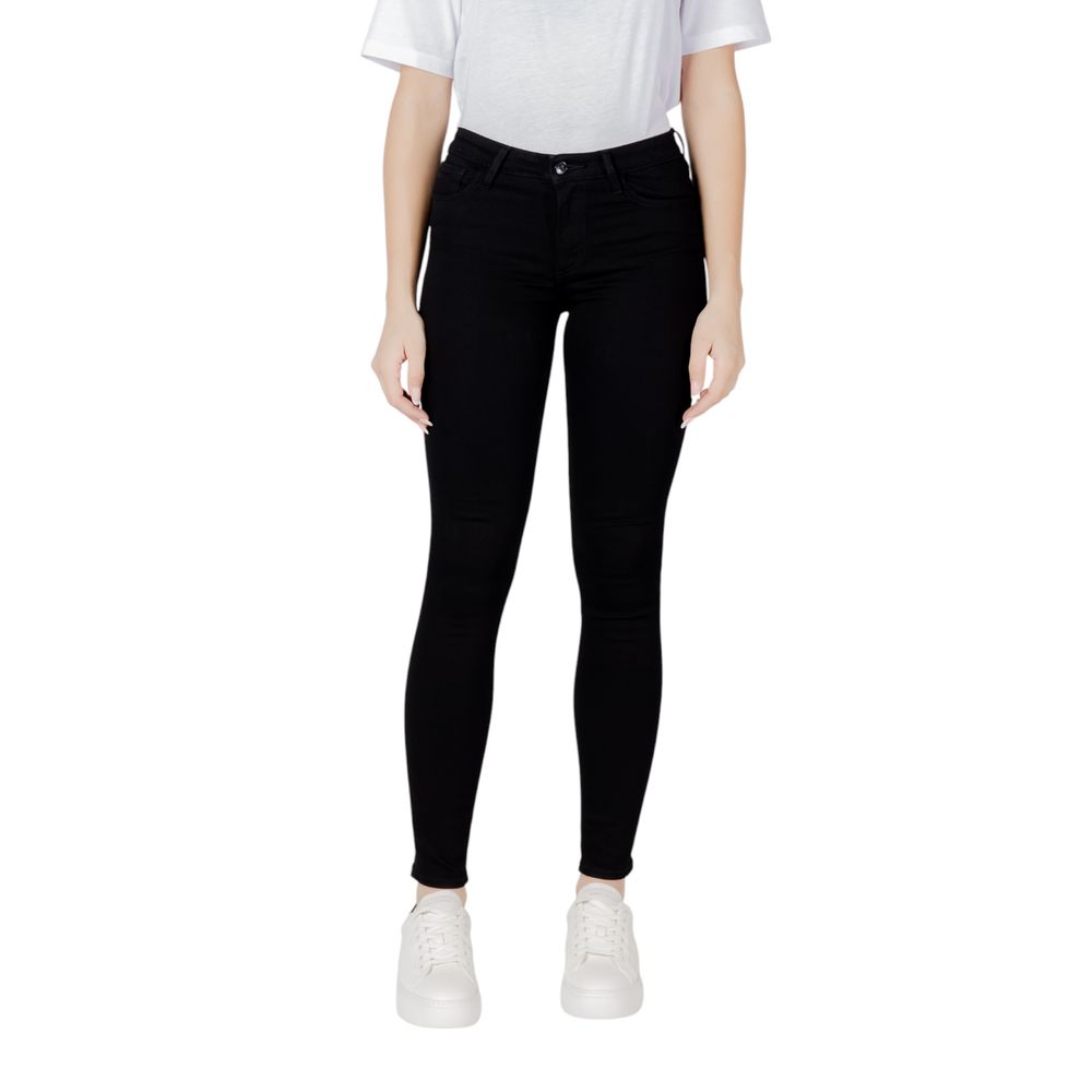 Woman wearing Armani Exchange Black Cotton Skinny Jeans showcasing sleek slim fit, ideal for versatile styling and comfort.
