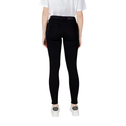 Woman wearing Armani Exchange Black Cotton Skinny Jeans from the back, showing slim design and perfect fit.