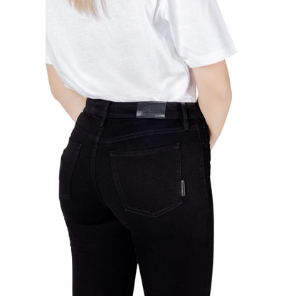 Back view of Armani Exchange Black Cotton Skinny Jeans worn with a white top, showcasing fit and style.