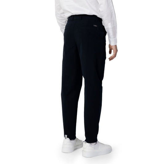 Back view of Armani Exchange Blue Cotton Pant worn by model, showcasing regular fit and stylish design with side and welt back pockets.