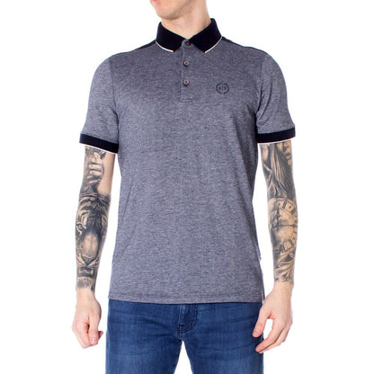 Model wearing Armani Exchange Blue Cotton Polo Shirt with tattoos, showcasing short sleeves and modern design.