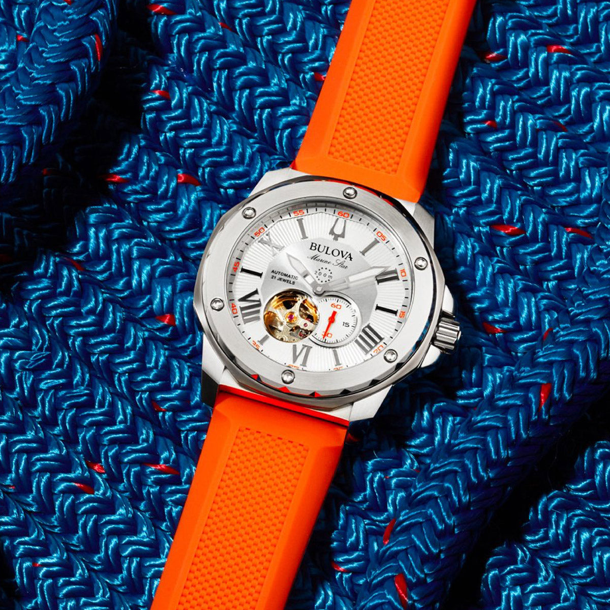 BULOVA WATCHES Mod. 98A226 with orange strap on blue textured background