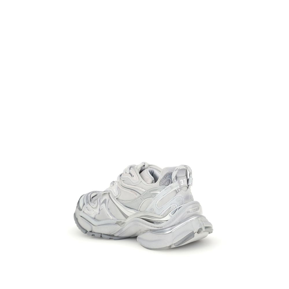 Balenciaga Silver Rubber Athletic Sneakers with worn-in effect and embossed logos, rear view on white background.