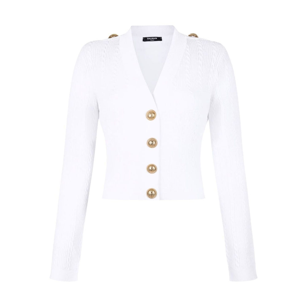 Balmain Button-Trim Cable-Knit Cardigan in white with gold shoulder and front buttons, V-neck, long sleeves, ribbed knit design.