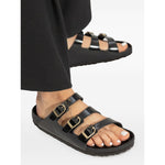 Birkenstock Sandals with buckle strap in black leather, slip-on style, narrow width, round open toe with rubber sole.