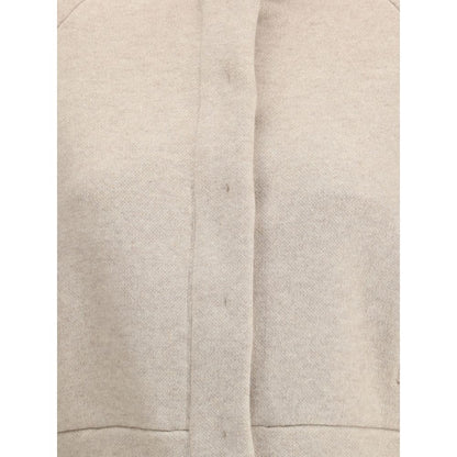 Close-up of Brunello Cucinelli Beige Cashmere Clothing featuring a button and zipper closure, highlighting beige texture and contemporary style.