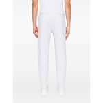 Back view of Brunello Cucinelli Cotton track pants in light grey with elasticated waistband and side slit pockets.