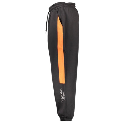 Calvin Klein Black Cotton Pant with elastic waistband, laces, ankle cuffs, side pockets, embroidery, contrasting orange detail, logo.