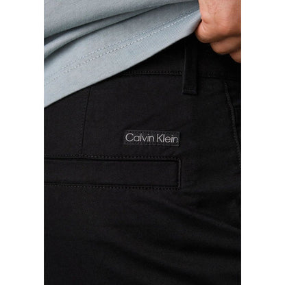 Close-up of Calvin Klein Jeans Black Recycled Cotton Chino Pants showing logo detail, emphasizing sustainable fashion.