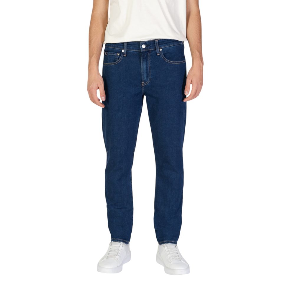 Calvin Klein Jeans Blue Cotton Slim Fit Jeans for men, tapered fit, sustainable fabric, styled with white sneakers.