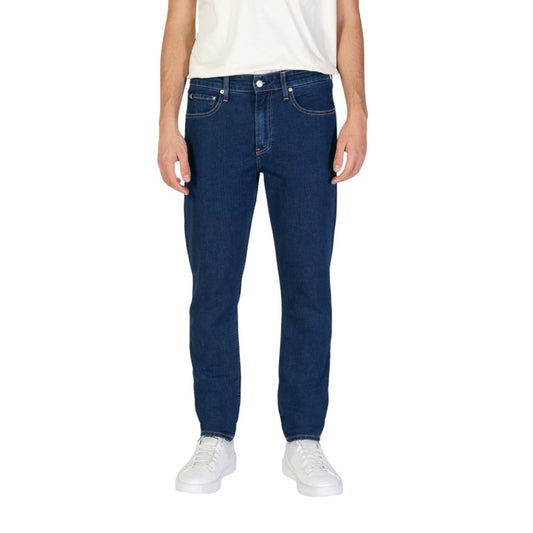 Calvin Klein Jeans Blue Cotton Slim Fit Jeans for men, tapered fit, sustainable fabric, styled with white sneakers.