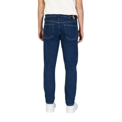 Back view of Calvin Klein Jeans Blue Cotton Slim Fit Jeans showcasing tapered fit and CK logo on waistband.
