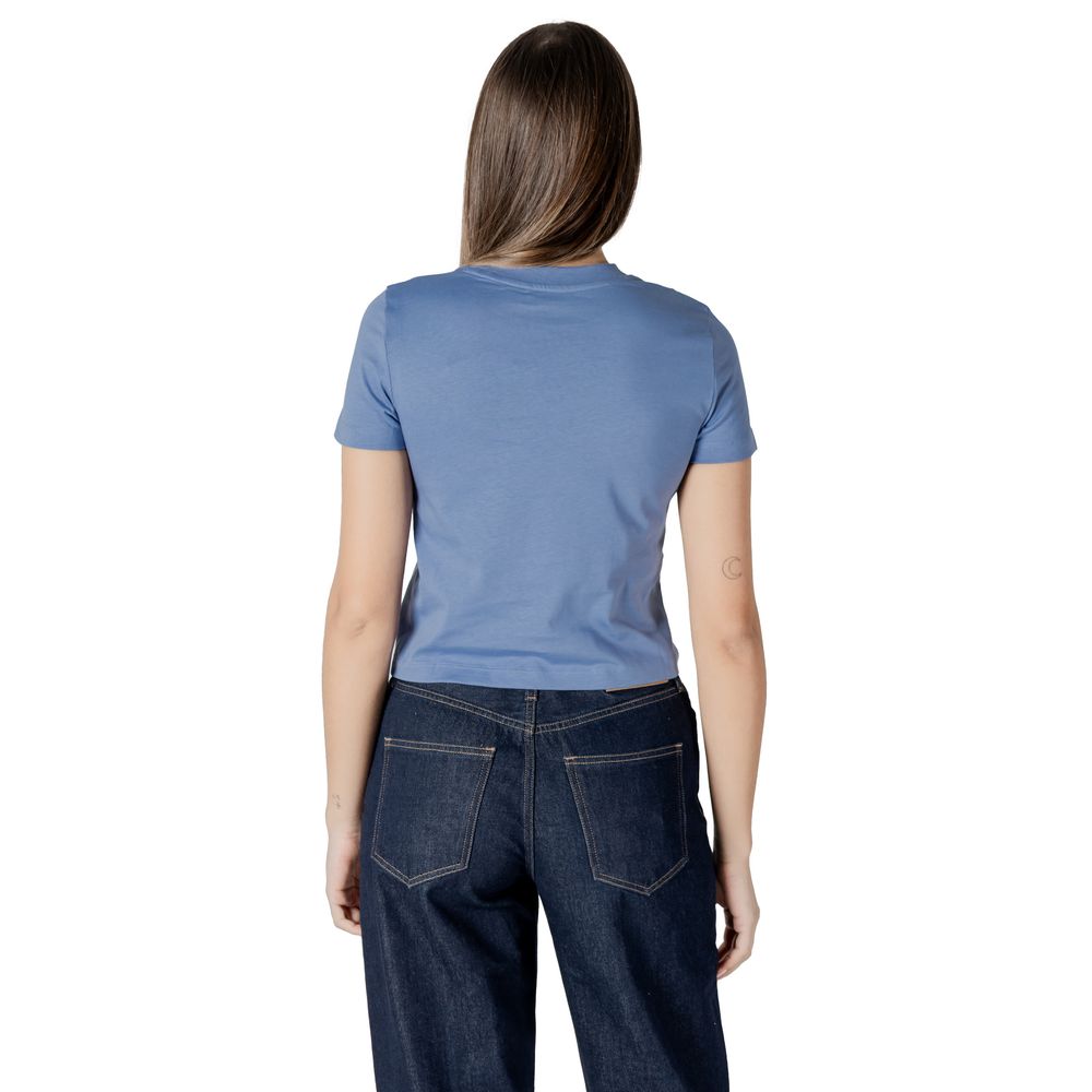 Back view of a woman wearing a Calvin Klein Jeans Light Blue Recycled Cotton Sportswear t-shirt in a minimalist design.