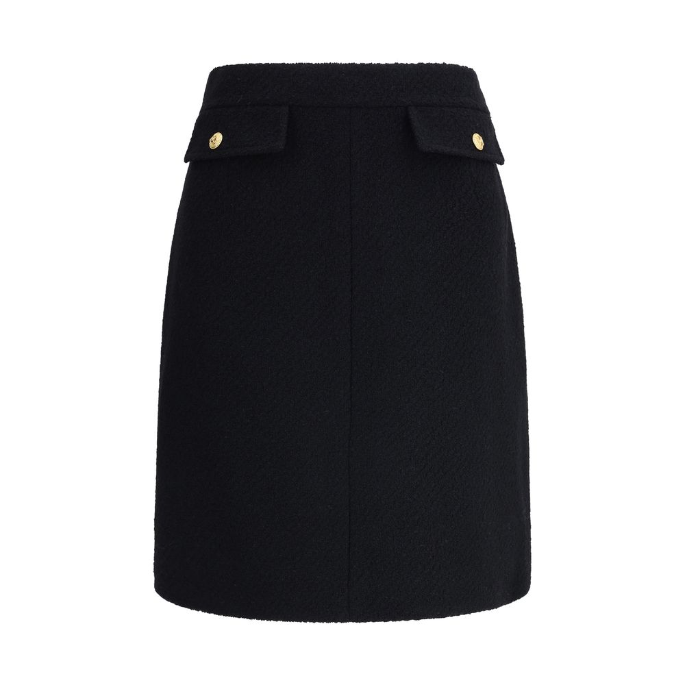 Chloé Black Wool Midi Skirt with gold-tone buttons and flap pockets, crafted from premium bouclé wool, AW25 collection.