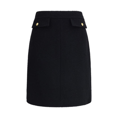 Chloé Black Wool Midi Skirt with gold-tone buttons and flap pockets, crafted from premium bouclé wool, AW25 collection.
