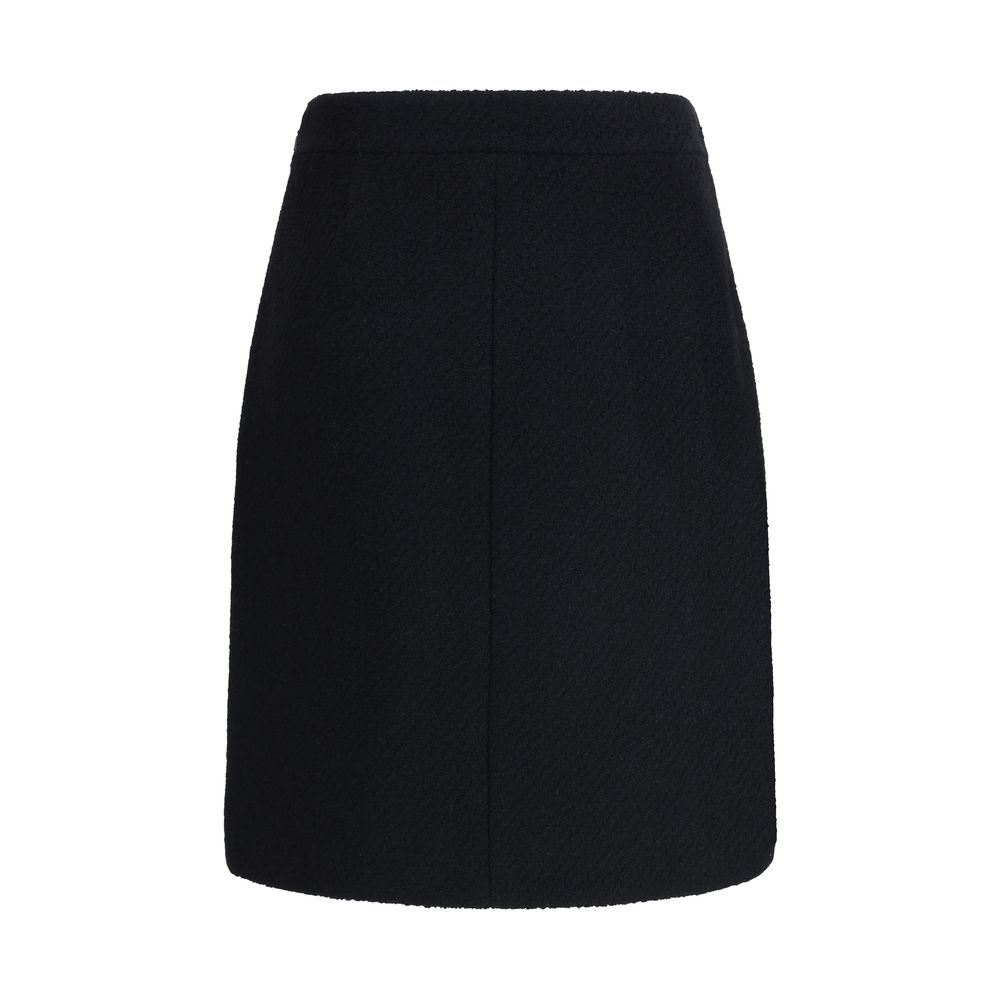 Chloé Black Wool Midi Skirt with front flap pockets and gold-tone buttons, crafted from premium bouclé wool for AW25 collection.