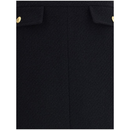 Close-up of Chloé Black Wool Midi Skirt with gold-tone button accents.