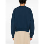 Back view of a model wearing a blue Chloé Chloè Sweaters Blue with long sleeves, mock neck, and straight hem.