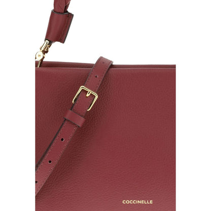 Coccinelle Bordeaux Calf Leather Bos Taurus Shoulder Bag with gold hardware and textured leather close-up.