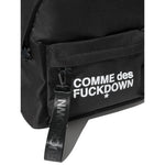 Comme Des Fuckdown Black Polyester Backpack with front logo, zip closure, and external pocket. Adjustable straps. Dimensions: 41x35x22 cm.