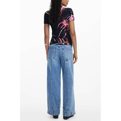 Back view of a woman wearing a Desigual Black Viscose Women Top with bold print, paired with wide-leg jeans.